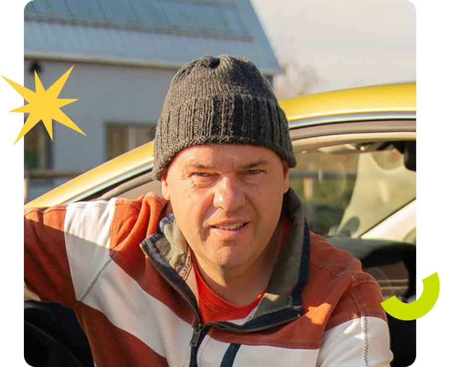 A man in a beanie and jacket leans against a yellow car, with a starburst and curved arrow graphic elements.