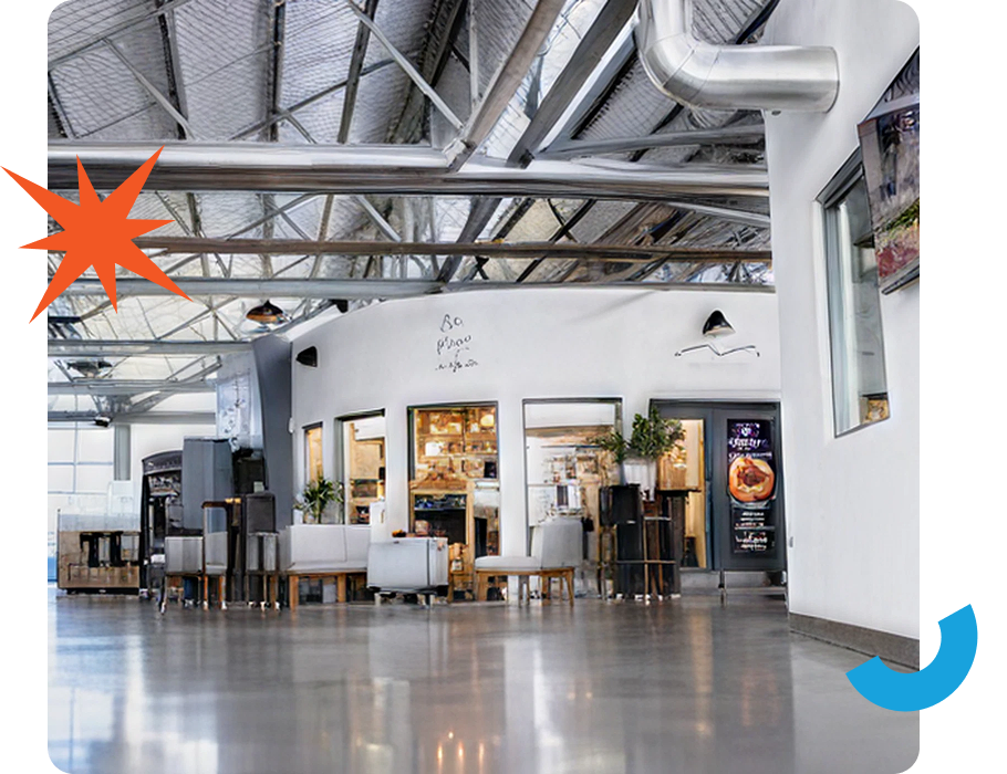 A modern interior with exposed metal beams, white walls, and a large open space featuring seating, a counter, and a poster.